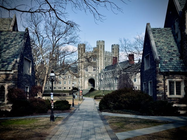 Gothic stone campus walkway between historic academic buildings